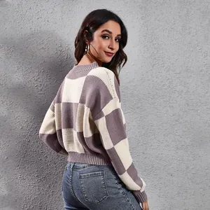 Back view of a cropped purple and cream checkerboard knit sweater with drop shoulders