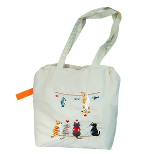 Cream canvas drawstring tote bag with cute embroidered cat design for daily use