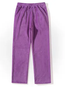 Close-up detail view of purple fuzzy fleece pants featuring soft texture and elastic waist