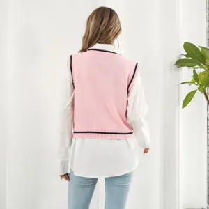 Back view of a pink Y2K knitted vest with contrast stripes over a white shirt