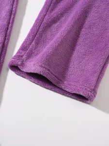 Close-up detail of the soft purple fleece fabric texture on autumn winter loungewear