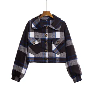 Detailed view of the plaid cropped jacket featuring a doll collar and lantern sleeves.