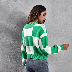 Detailed view showing the side profile of a green and white checkered cropped knit sweater