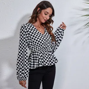Detail view of v-neck checkered chiffon blouse with cinched waist and lantern sleeves