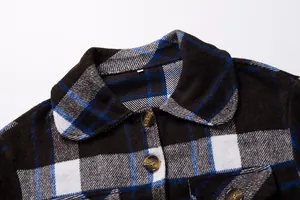Close-up of plaid wool jacket featuring a Peter Pan collar and marble-effect buttons