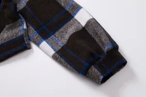 Close-up of plaid lantern sleeve on soft wool jacket featuring blue and brown patterns.