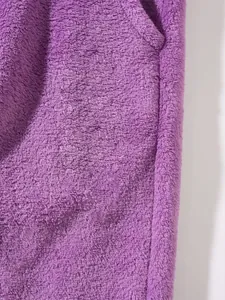 Detailed macro shot of soft purple fleece fabric showing dense texture for warm winter sets.