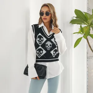 Detail view of a black Y2K knitted vest featuring white skull and argyle jacquard patterns.