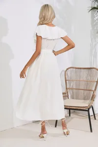 Back view of an elegant white sleeveless maxi dress with ruffled collar and belt