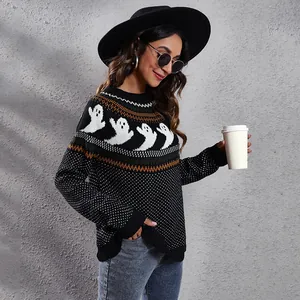 Detail view of a loose knit sweater featuring festive ghost jacquard and polka dots