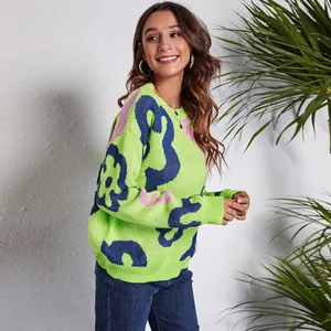 Perspective shot of the abstract floral jacquard detail on a lime green knit sweater