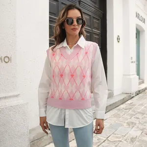 Lifestyle detail of a pink Y2K argyle knit vest with heart motifs over a white shirt.