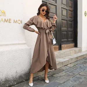 Detail view of brown ruffle V-neck long-sleeve wrap dress with asymmetrical hemline