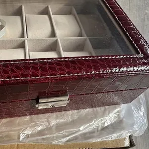 Dettaglio della scatola per orologi in pelle di coccodrillo bordeaux con vetro