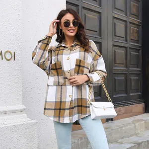 Stylish women's brown plaid long-sleeve wool shacket in a modern outdoor setting
