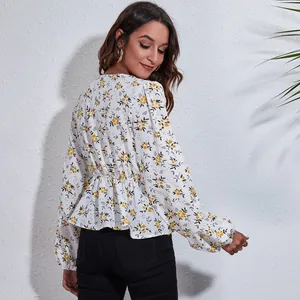 Back view of a white floral V-neck chiffon blouse with lantern sleeves and elastic waist