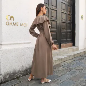 Detailed side view of elegant brown long-sleeved maxi dress with ruffle collar
