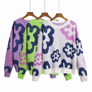 Detailed display of three floral jacquard drop shoulder sweaters in purple, green and white