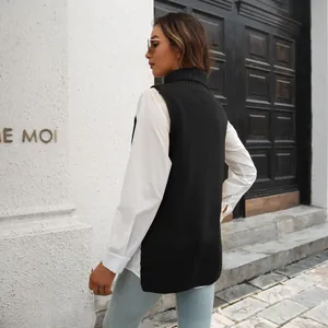 Back view of a black high-neck knit vest layered over a white shirt on a model