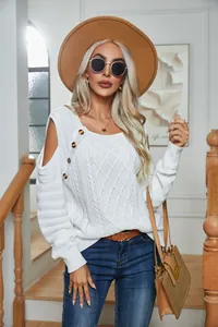 Detailed shot of white cable knit sweater with button accent and cold shoulder design