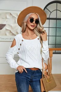 White cable-knit cold-shoulder sweater with decorative buttons and square neckline.