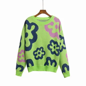 Front view detail of a green knit sweater with blue and pink floral jacquard patterns