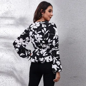 Detailed back view of black and white floral print chiffon blouse with lantern sleeves