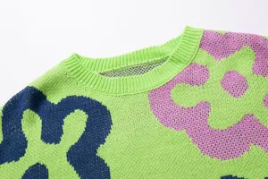 Detail of vibrant floral jacquard knit sweater showing ribbed crew neckline