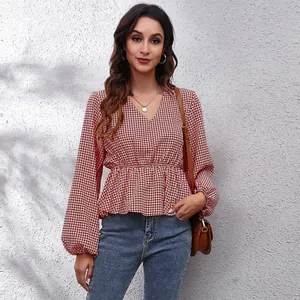 Red and white houndstooth V-neck chiffon blouse with lantern sleeves and cinched waist.