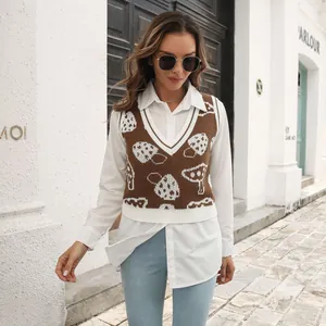 Model wearing a brown mushroom jacquard knit vest over a white shirt in a street style shot