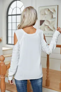 Back view of white cold-shoulder long sleeve knitted sweater showing ribbed texture