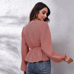 Detailed view of the red and white houndstooth chiffon top featuring stylish lantern sleeves