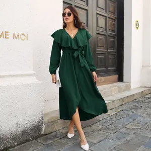 Dark green long sleeve dress with ruffle V-neck and high-low wrap hem worn by model