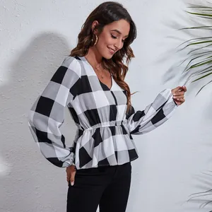 Elegant black and white plaid V-neck peplum blouse with lantern sleeves for women.