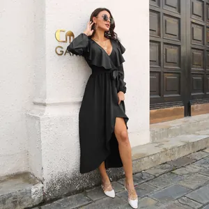 Elegant black V-neck maxi dress with ruffles and long sleeves in outdoor setting