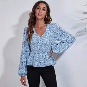 Close-up of blue floral V-neck chiffon blouse with lantern sleeves and cinched waist