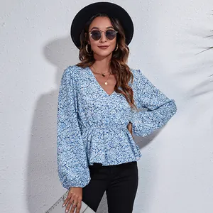 Detail showing the floral print and V-neckline of this elegant blue lantern sleeve blouse