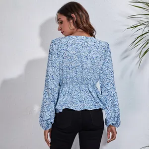 Back view of a floral print lantern sleeve chiffon blouse with cinched waist detailing