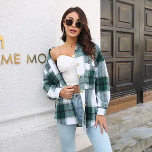 Outdoor view of a stylish green and white plaid long sleeve shirt jacket for women.