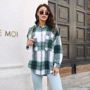 Casual green plaid flannel shirt jacket worn by a model in a stylish urban setting.