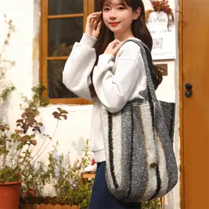 Chic large striped fleece tote bag for women carried by model in an outdoor setting