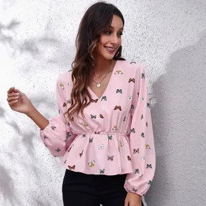 Detailed view of pink V-neck chiffon blouse with butterfly prints showing fit and sleeves