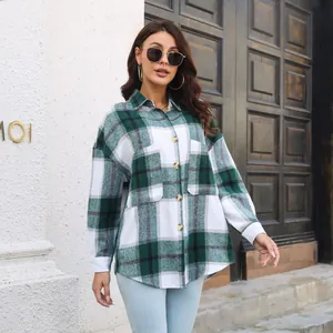 Detailed outdoor shot of a woman wearing a green and white plaid wool-blend shacket.
