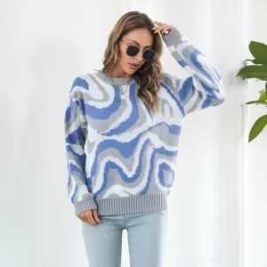 Close-up view of the wave jacquard pattern on this blue and grey knitted sweater.