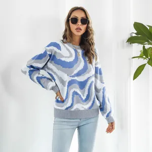 Close-up of a women's oversized jacquard knit sweater with blue and grey wave patterns.