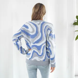 Back view of woman's casual knit sweater with abstract blue and grey marble wave pattern