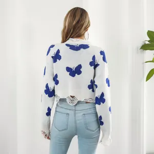 Back view showing distressed hem of Y2K white knit sweater with blue butterflies