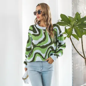 Close-up detail of a women's oversized knit sweater featuring green wavy tie-dye patterns