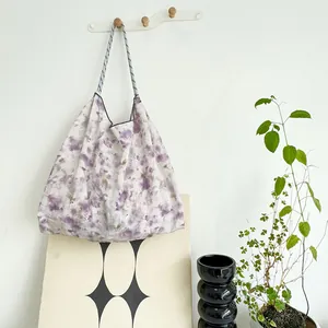 Large floral canvas tote bag for resort beach vacations hanging in a home setting
