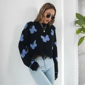 Y2K distressed black knit sweater with blue butterfly jacquard detail and ripped hem
